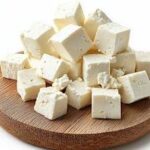 Fresh organic cow milk paneer cubes on a wooden board at SAAM farm Islamabad